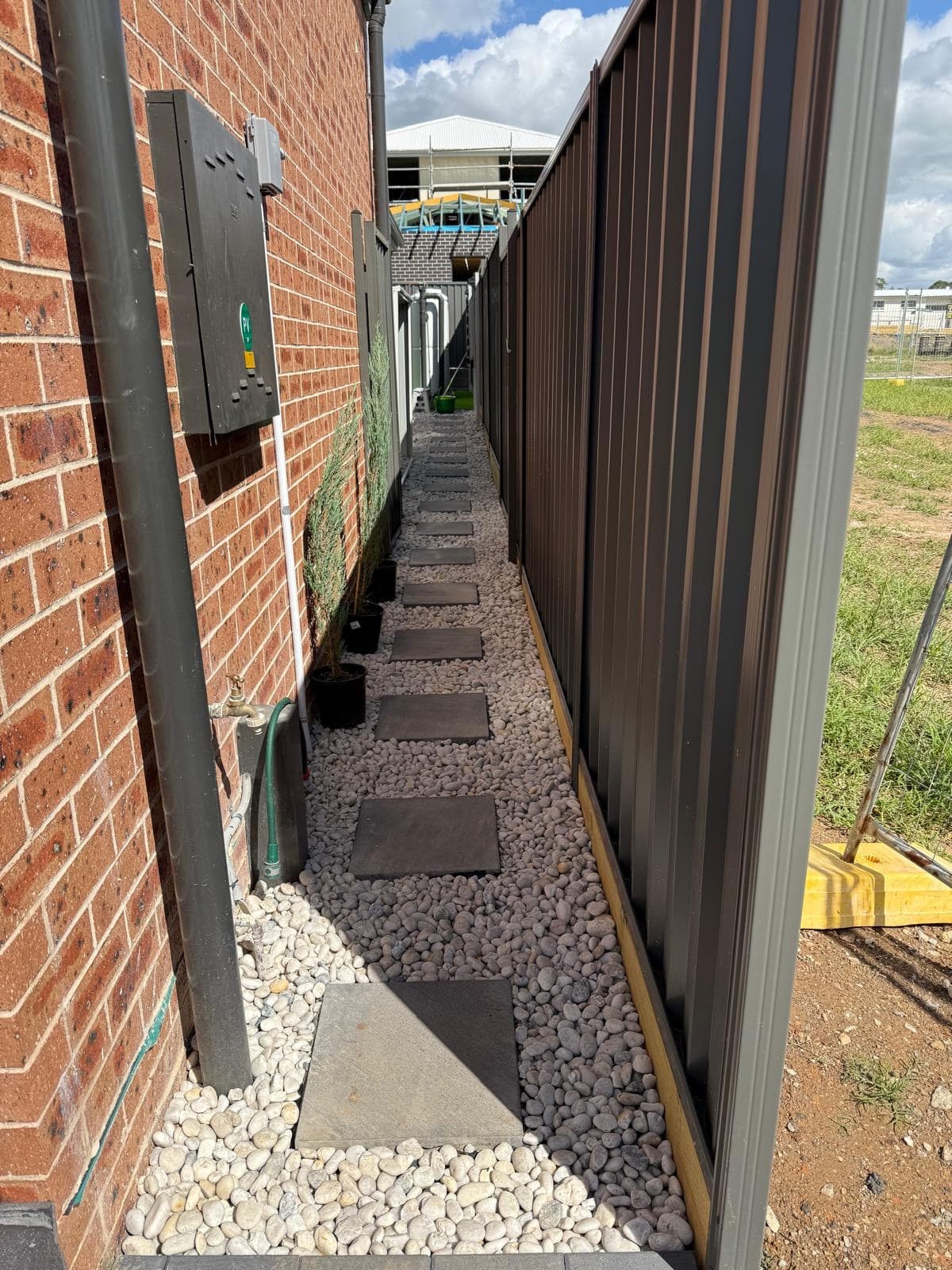 Residential garden entrance Sydney - exposed aggregate driveway with tropical garden border